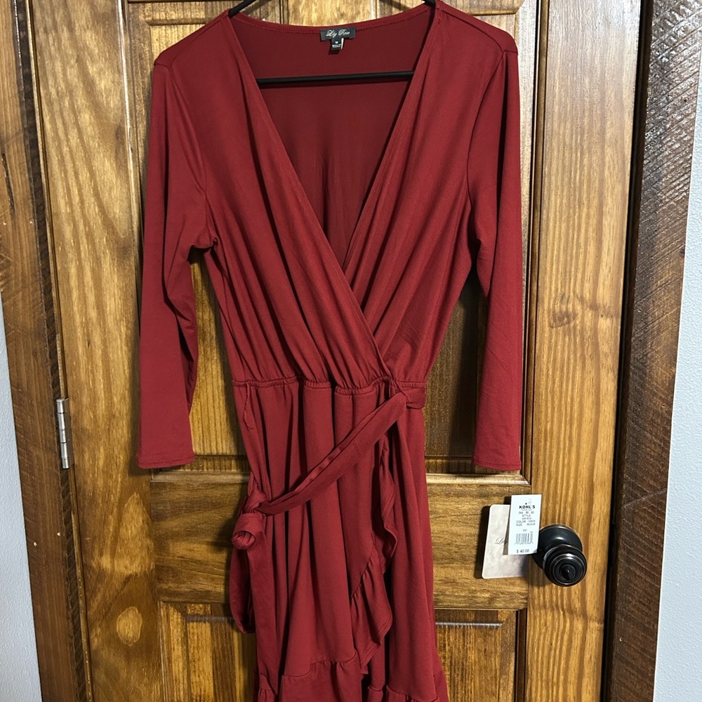 Lily Rose burgundy wrap Dress with tie waist. V neck line with ruffled hem
